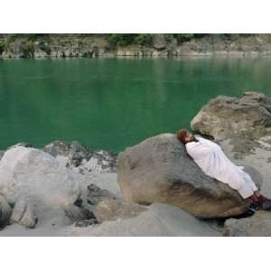 Hindu Pilgrim Rests Along the Peaceful Bank of the Ganges River Near 