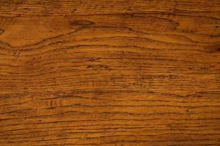 The solid oak displays a rich complexion and a pronounced grain.