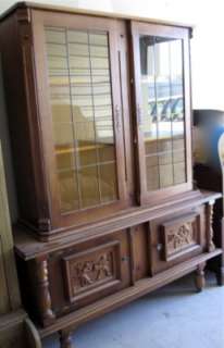 beautiful paned glass doors wood cabinet with carved pictorial doors 